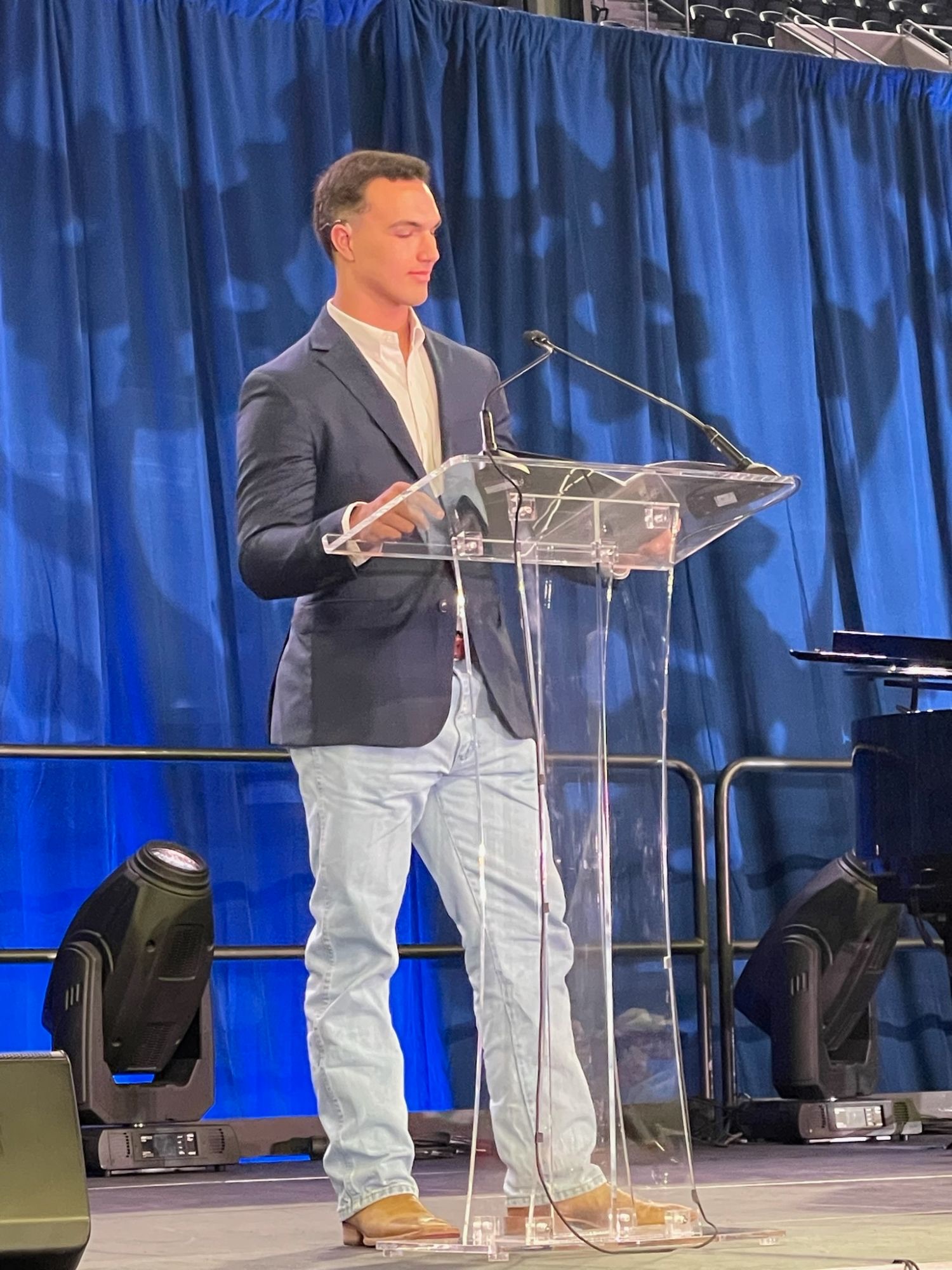 Randell speaking at a podium